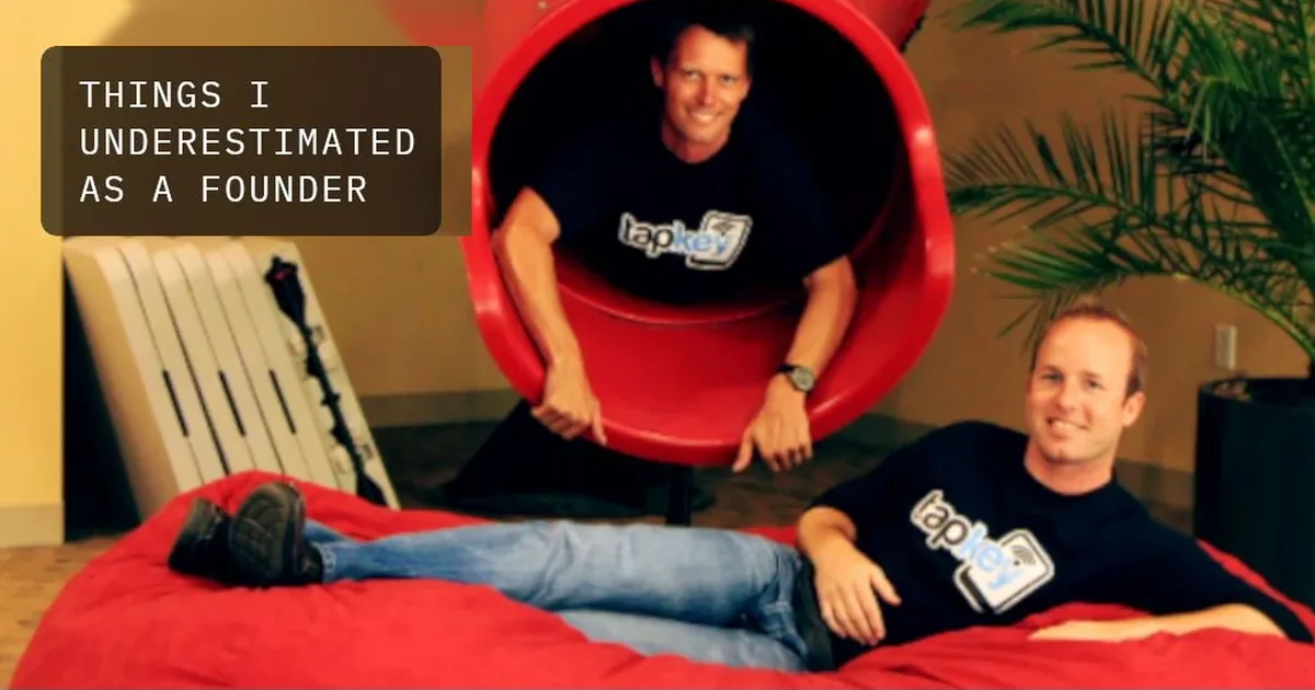 Two team members in Tapkey T-shirts at a red office slide